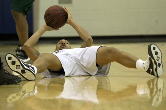 Ethan Magoc photo: Mercyhurst College's Bill Weaver holds onto the ball while on his back during the second half against Slippery Rock on Tuesday, March 1, 2011 at the Mercyhurst Athletic Center.